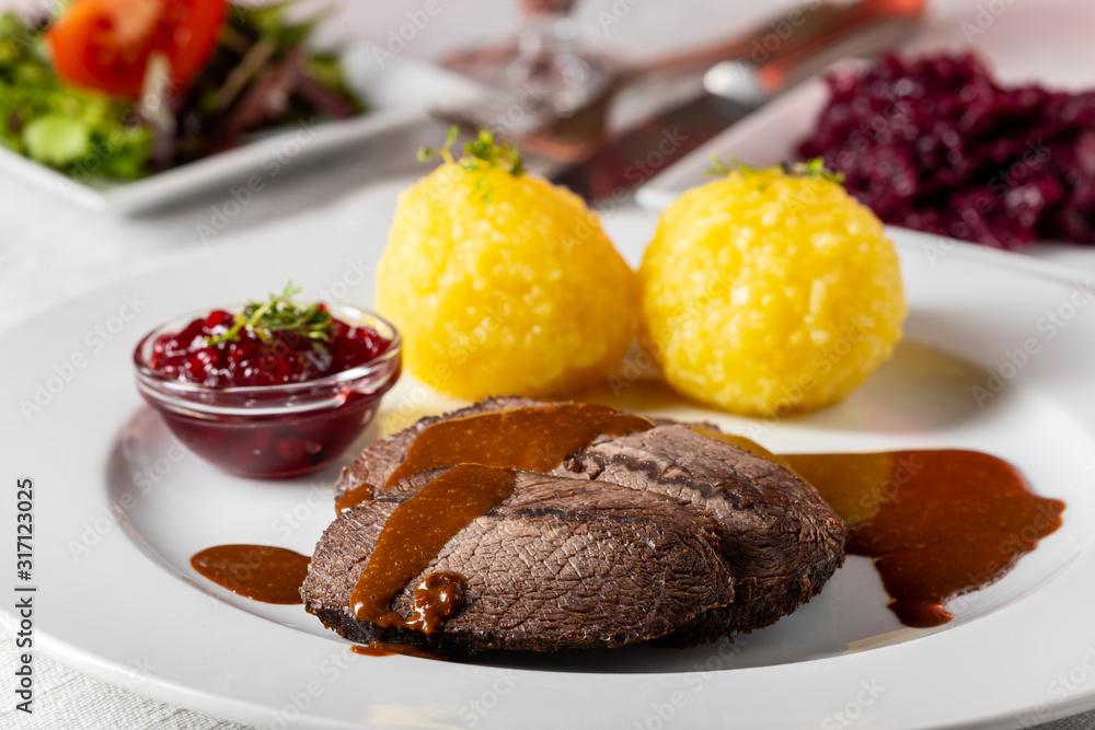 closeup of a german sauerbraten with dumplings closeup of a german sauerbraten with dumplings