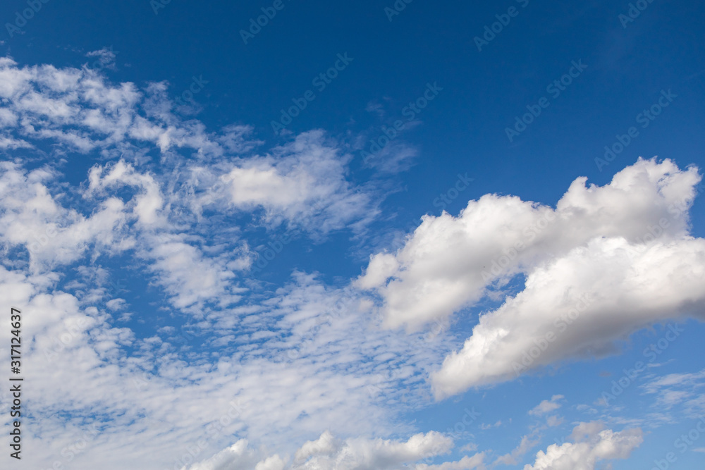 Sky and clouds during the evening in the summer. The setting sun highlights the clouds below Sky and clouds during the evening in the summer. The setting sun highlights the clouds below