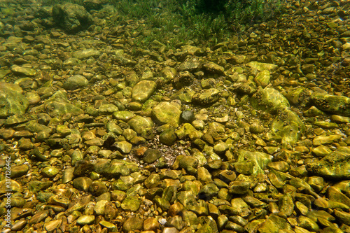 Rocky river bottom of the Licka Jesenica River photo