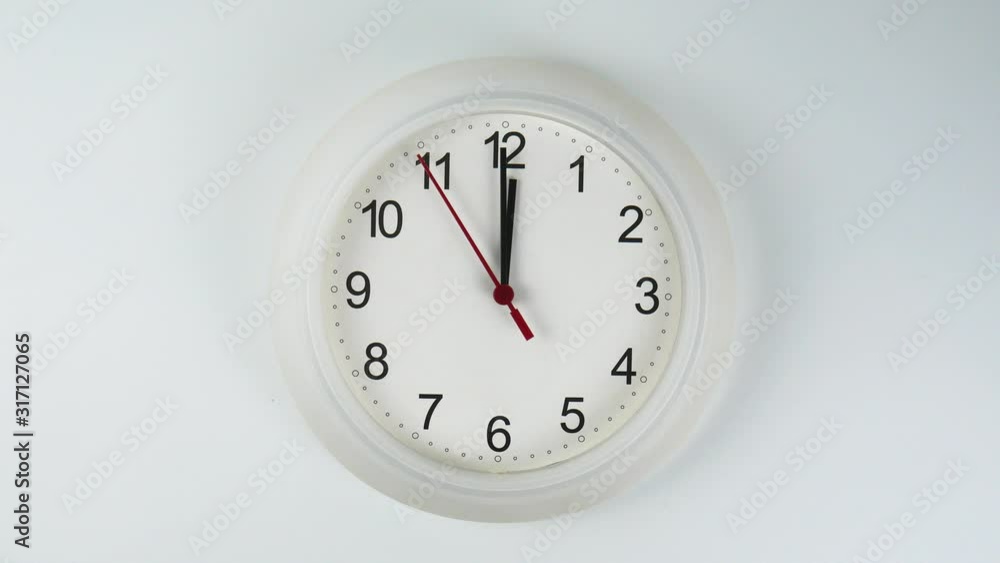 Twelve o'clock White wall clock face beginning of time 12.00 am. on White background. Twelve o'clock White wall clock face beginning of time 12.00 am. on White background.
