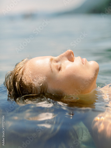 Portrait of beautiful woman in the sea water
