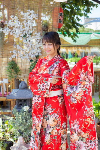 The girl is wearing a red traditional kimono, which is the national dress of Japan © powerbeephoto