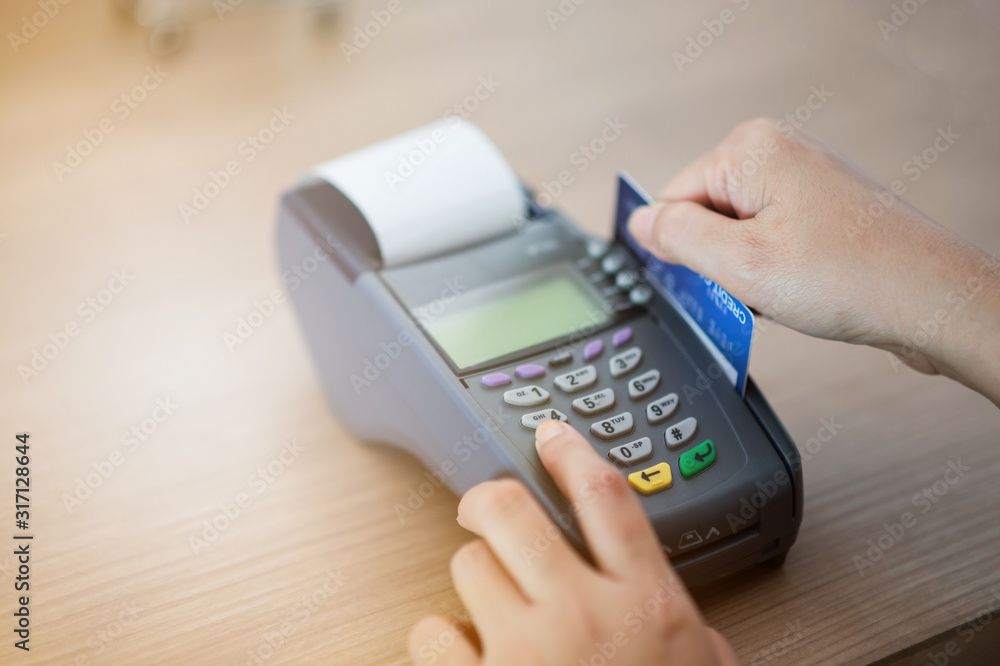 Close-up, focusing on capturing credit card payments, swiping credit cards, not using cash. Close-up, focusing on capturing credit card payments, swiping credit cards, not using cash.