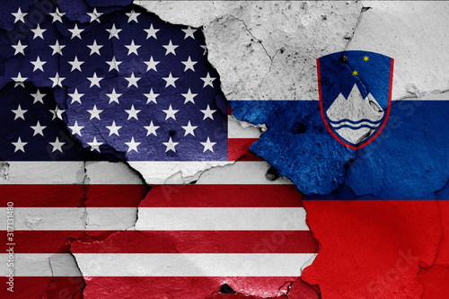 Принти на полотні flags of USA and Slovenia painted on cracked wall