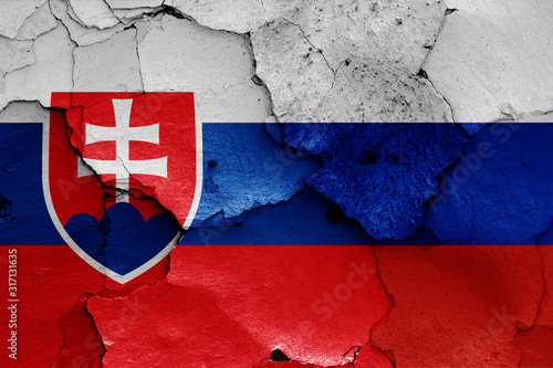 flags of Slovakia and Russia painted on cracked wall