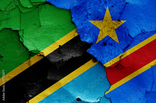 flags of Tanzania and DR Congo painted on cracked wall