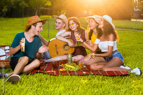 Group of young musicians on picnic party.