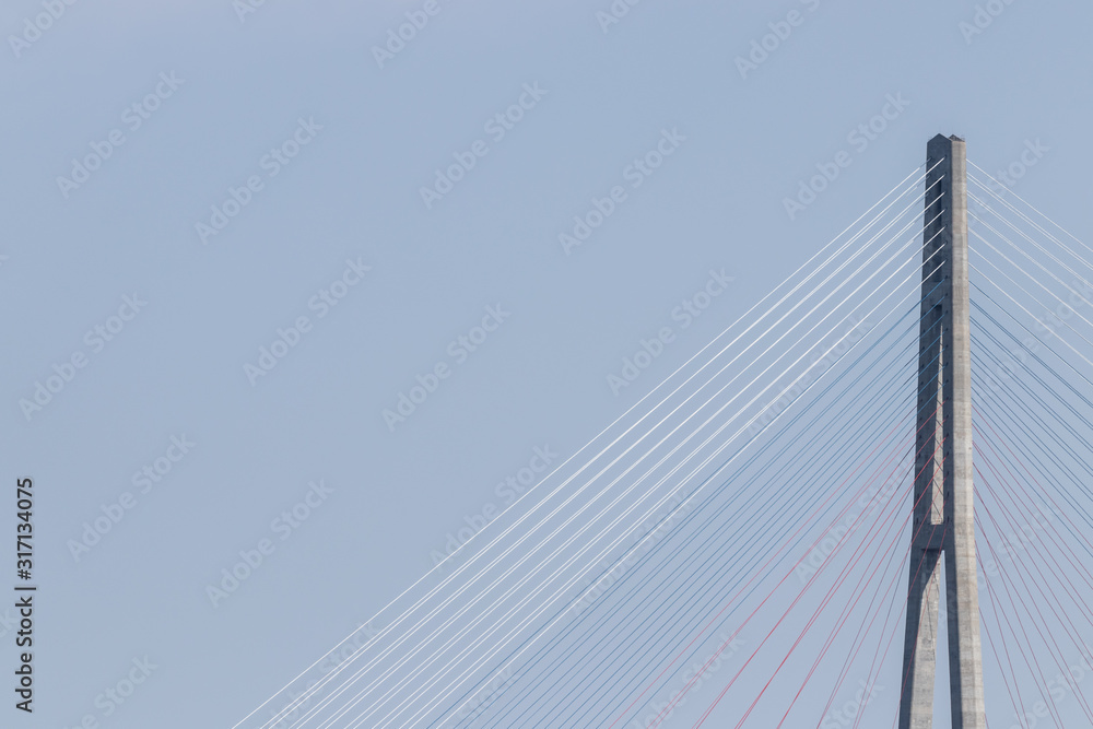 Horizontal photo of a pylon bridge against a pale blue sky Horizontal photo of a pylon bridge against a pale blue sky