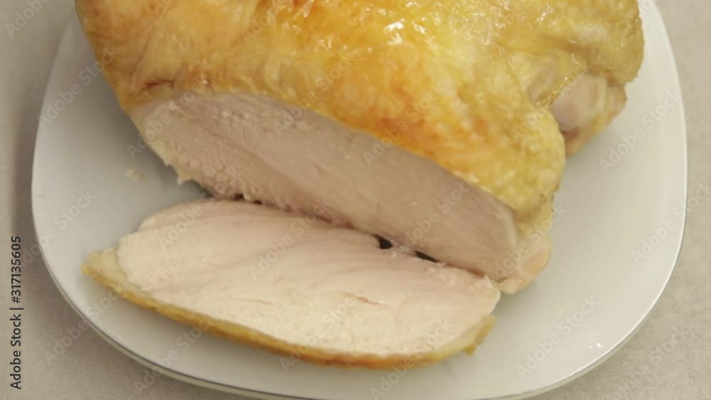 close-up baked chicken breast with sliced piece