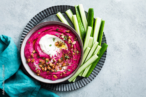 Pink beet cashew hummus swirled with garlic yogurt tahini and sprinkled with roasted almond za’atar.