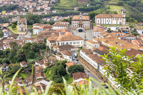 Central square of colonial mining city centre Ouro Preto in Minas Gerais, Brazil, with facade of the Museum of Inconfidence and Tiradentes monument seen from a high altitude and large distance