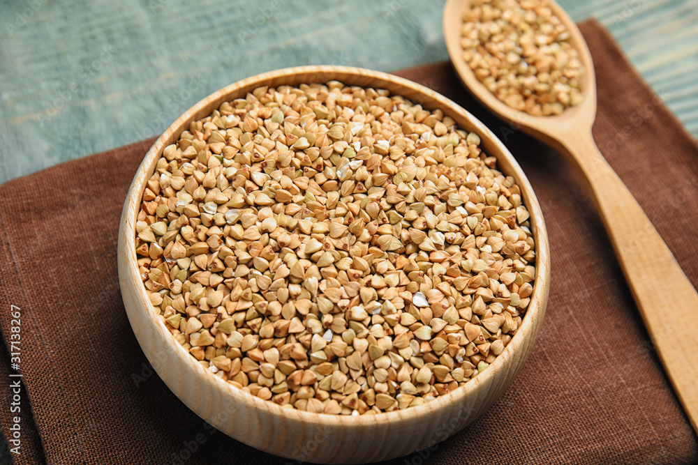 Uncooked green buckwheat grains on table, closeup Uncooked green buckwheat grains on table, closeup