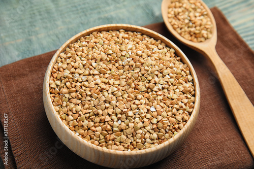 Uncooked green buckwheat grains on table, closeup