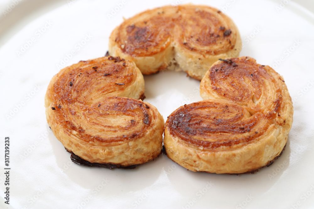 three palmier pastries on white plate