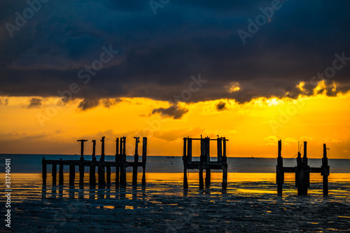 The abstract wallpaper of the blurred nature of the colorful multicolored sky by the large lake  with the golden yellow sky from the light that hits the morning sun.