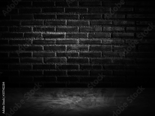 dark room with brick wall and wooden floor