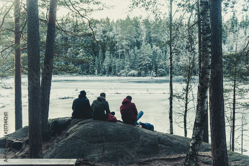 three men on a rock