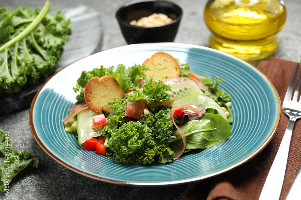 Delicious salad with kale leaves on table Delicious salad with kale leaves on table