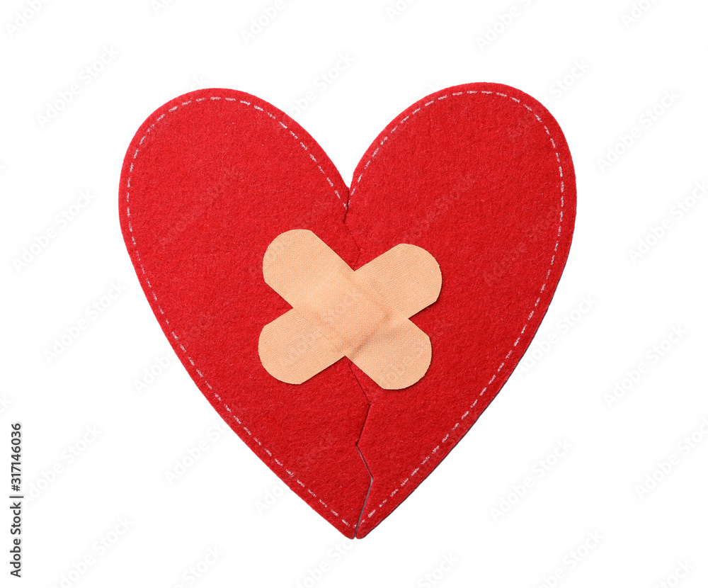 Red fabric heart with sticking plasters isolated on white, top view