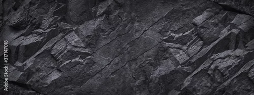 Obraz  z motywem Black white stone background. Dark gray grunge banner. Mountain texture. Close-up. Volumetric.  Rock background with space for design. Detail.  Wide banner. Long. Panoramic.