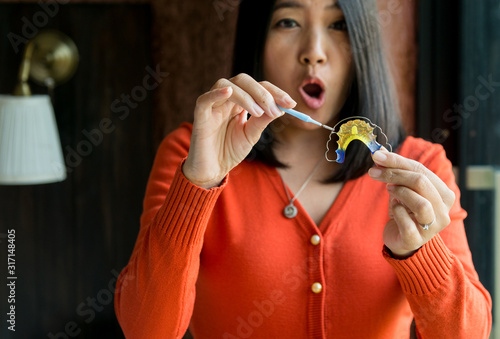 Woman using braces teeth or silicone trainer,Orthodontic,Dental health concept photo