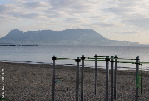 exercise on the beach getares with the rock of Gibraltar in the background.