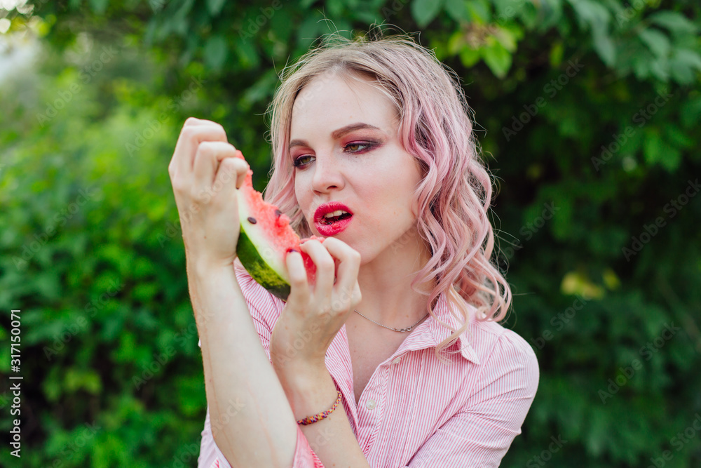 Beautiful young woman with pink hair enjoying watermelon Beautiful young woman with pink hair enjoying watermelon
