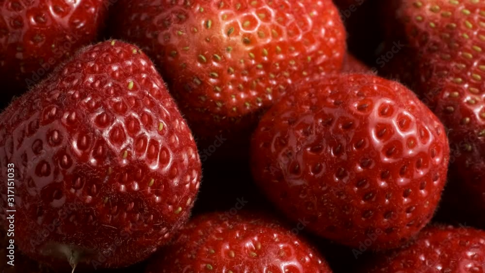 Slow motion rotation of fresh strawberries. Top view, Rotation 360 degrees, Extreme close up. Slow motion rotation of fresh strawberries. Top view, Rotation 360 degrees, Extreme close up.