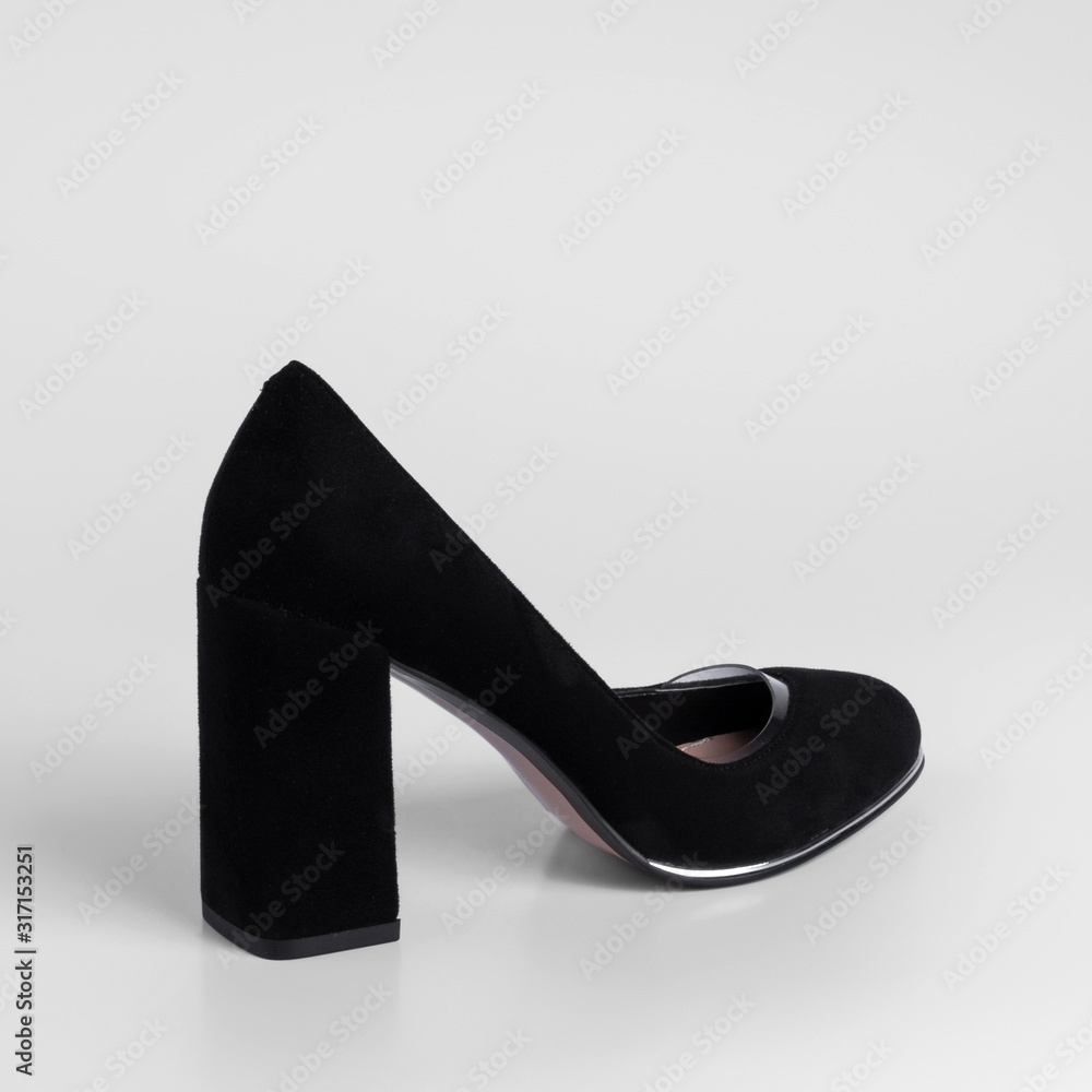 Womens black suede shoes with transparent inserts on a high thick heel. Close-up. Catalog shooting Womens black suede shoes with transparent inserts on a high thick heel. Close-up. Catalog shooting