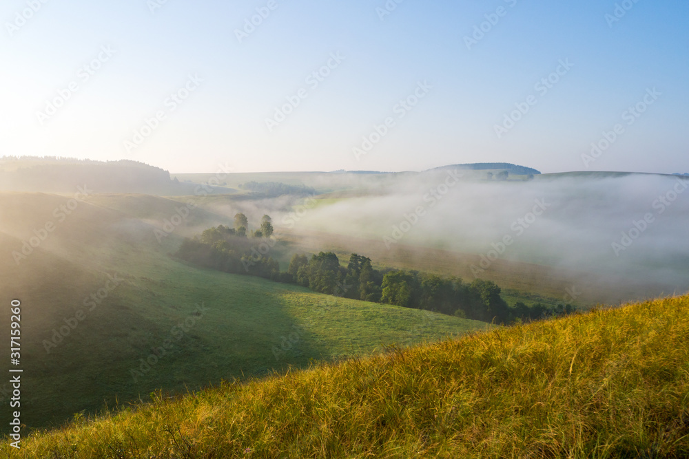 Misty morning, dawn. Beautiful summer countryside landscape.