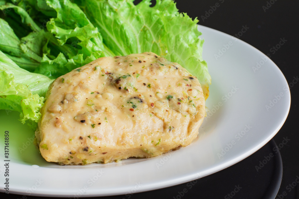 Chicken breast steak with spices serve with fresh green lettuce on white plate. High protein food. Healthy for loose weight. Chicken breast steak with spices serve with fresh green lettuce on white plate. High protein food. Healthy for loose weight.
