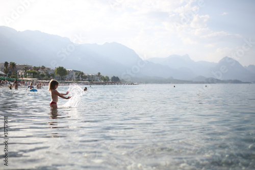 Child girl in the sea, mountains, Turkey