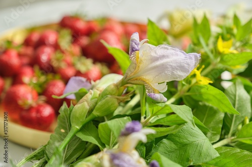 Berries of red ripe strawberry on white table in golden tray