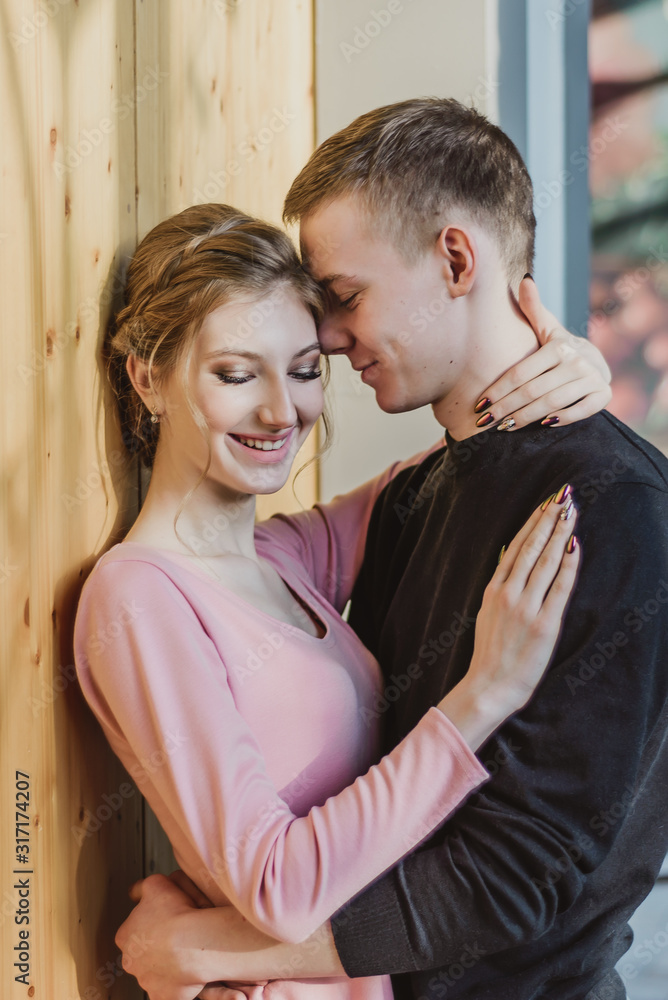 beautiful couple young girl and guy hugging. lovers at the moment of intimacy on a date in a cafe. the concept of first love in adolescence beautiful couple young girl and guy hugging. lovers at the moment of intimacy on a date in a cafe. the concept of first love in adolescence