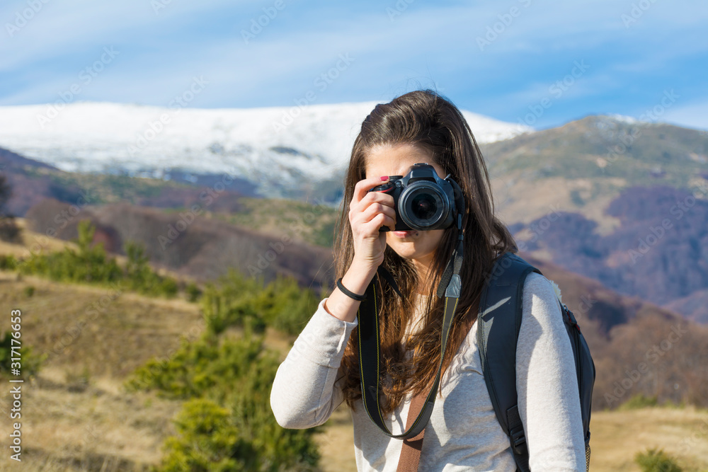 Woman in the High Snowy Mountain with Photo Camera.Winter Vacation Concept .Photographer in the Mountain Woman in the High Snowy Mountain with Photo Camera.Winter Vacation Concept .Photographer in the Mountain