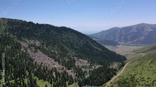 Grigorievskoe gorge in the summer in Kungei Alatau. Kyrgyzstan.  Forest, Alpine meadows and glaciers. photo