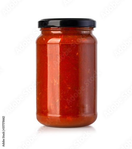 Tomato sauce jar on white photo