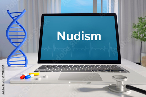 Nudism – Medicine/health. Computer in the office with term on the screen. Science/healthcare