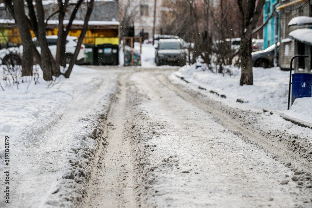 Winter. Uncleaned streets with heavy snowdrifts after snowfall in the city, cars under the snow. Puddles. icy roads. icy streets Winter. Uncleaned streets with heavy snowdrifts after snowfall in the city, cars under the snow. Puddles. icy roads. icy streets