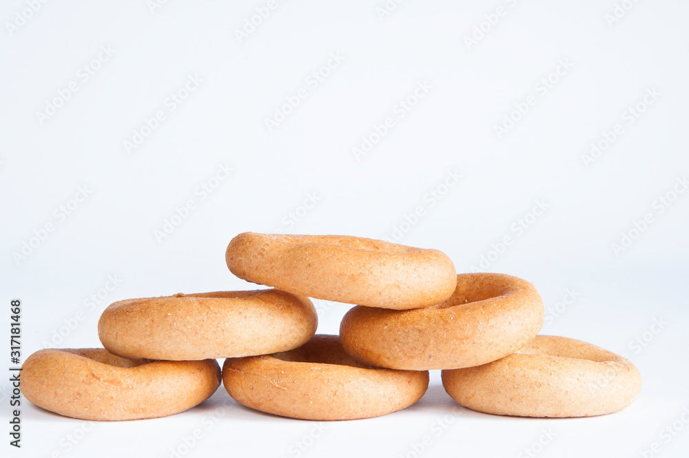 Delicious dried pastries stacked in a pile on a table on a white background. Delicious dried pastries stacked in a pile on a table on a white background.