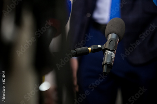 Hand with microphone doing an interview for the media, selective focus