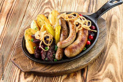 homemade food pan with grilled sausages and vegetables