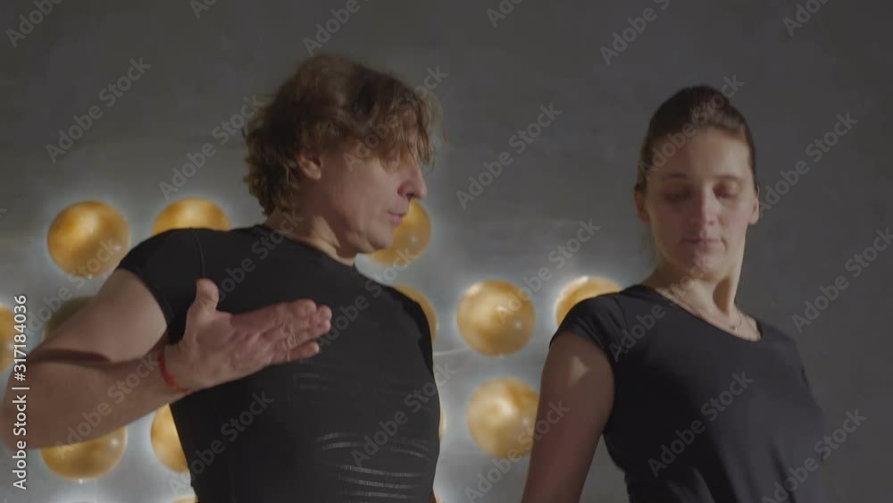 Trainer shows student new dance moves close-up