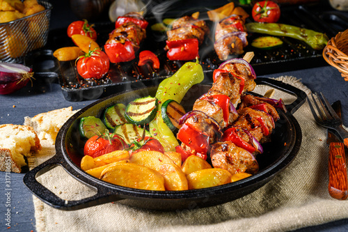 Shish kebab with various vegetables and spice country potatoes