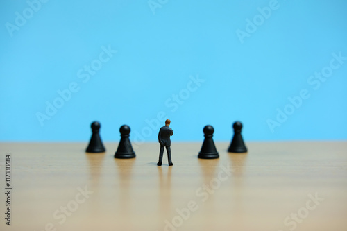 Business strategy conceptual photo - Miniature of businessman thinking in front of chess piece 