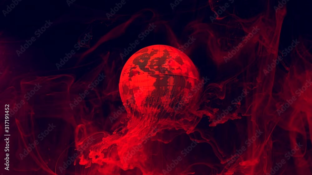 Planet earth on a fiery background. Red-orange watercolor ink in water ...