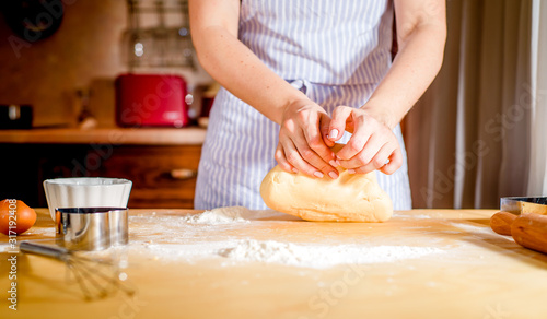 fingers on dough, chef kneads dough for baking, concept cooking, bakery