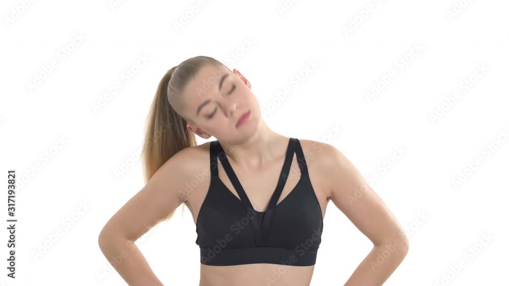 Close-up demonstration video of the attractive athletic woman doing fitness exercises. She is rounding her head. Isolated studio shot on white background Close-up demonstration video of the attractive athletic woman doing fitness exercises. She is rounding her head. Isolated studio shot on white background