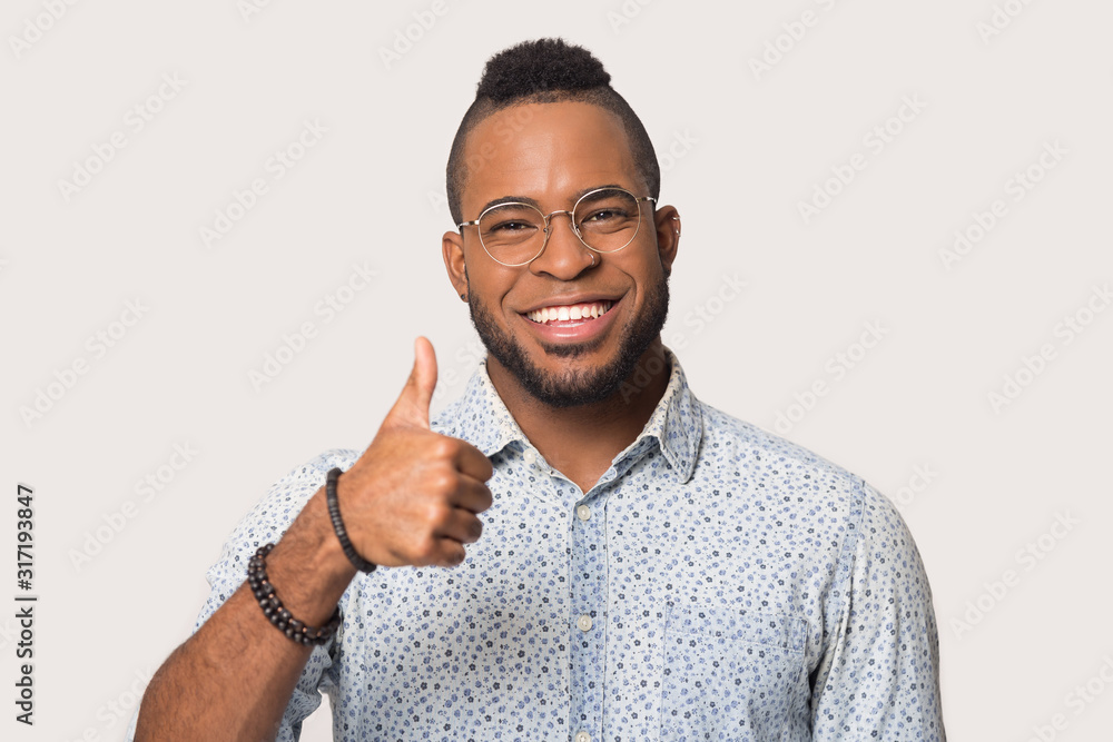 Smiling black male show thumb up recommending service Smiling black male show thumb up recommending service