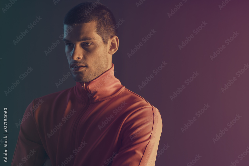 Studio close-up portrait of attractive male model. Color flash studio light Studio close-up portrait of attractive male model. Color flash studio light